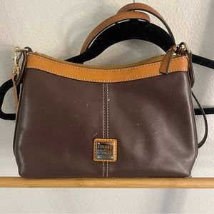 Dooney& Bourke crossbody bag, please see pictures it has scratches.